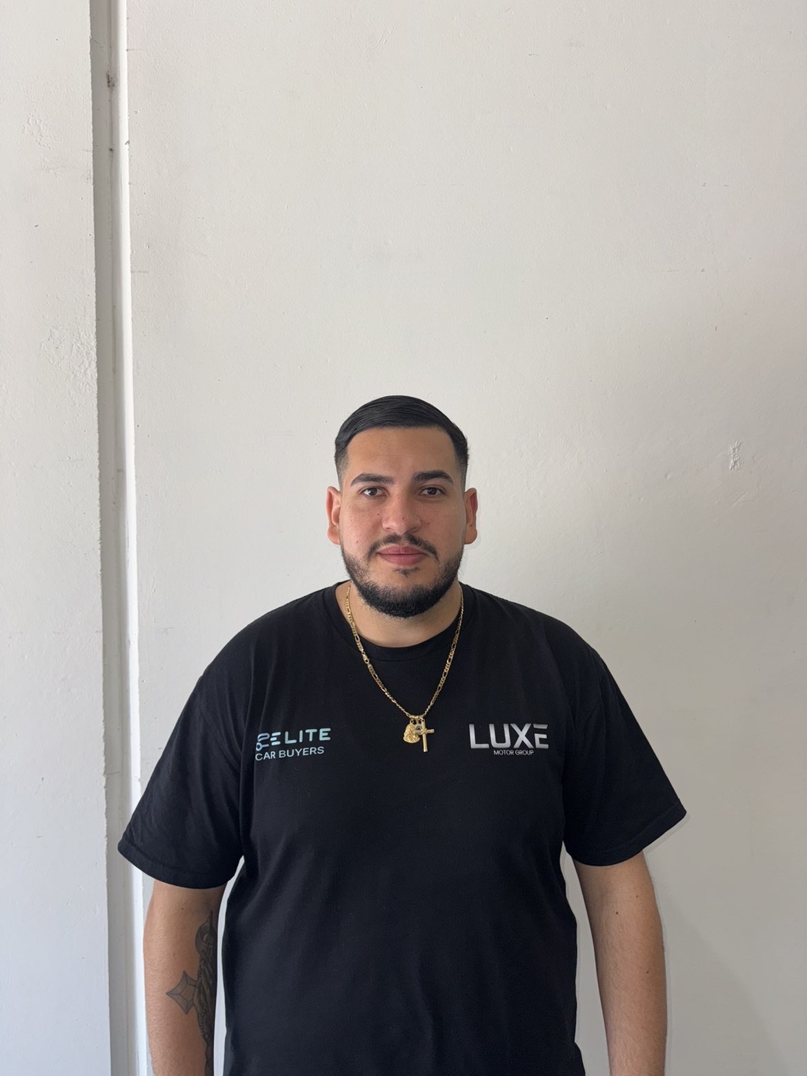 Jayson Barsoum, the owner of Luxe Motor Group, wearing a Luxe branded shirt